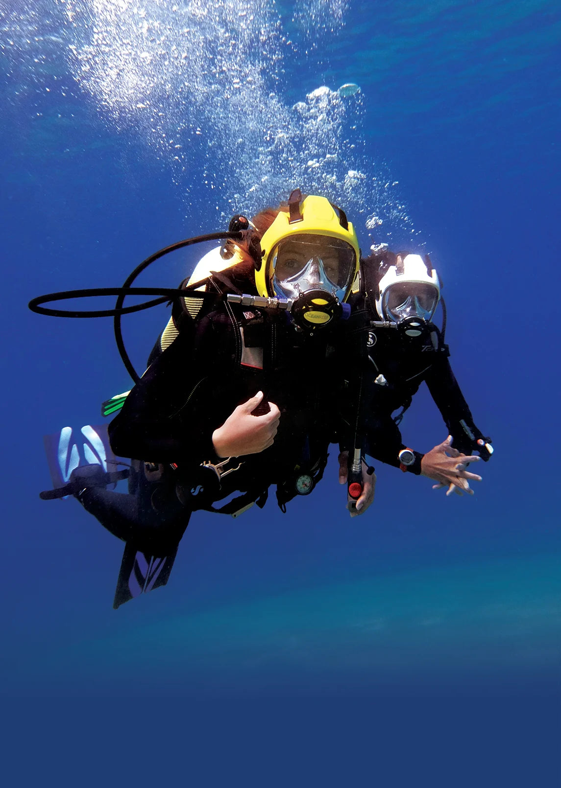 A scuba diver wearing a yellow full-face mask.
