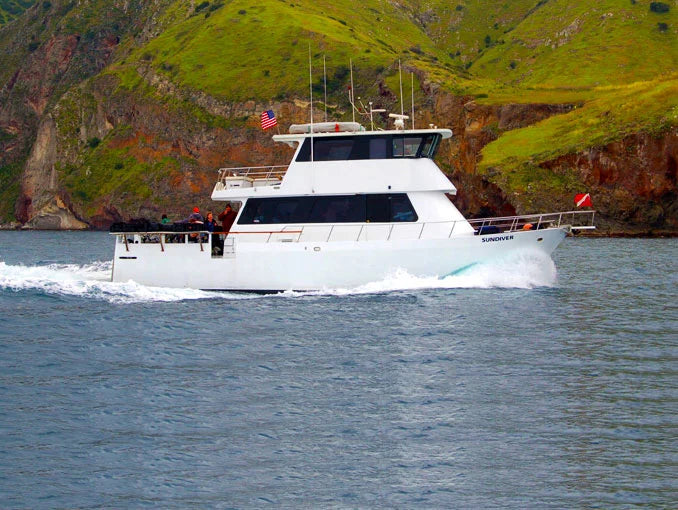 Sundiver dive boat alongside an island coast