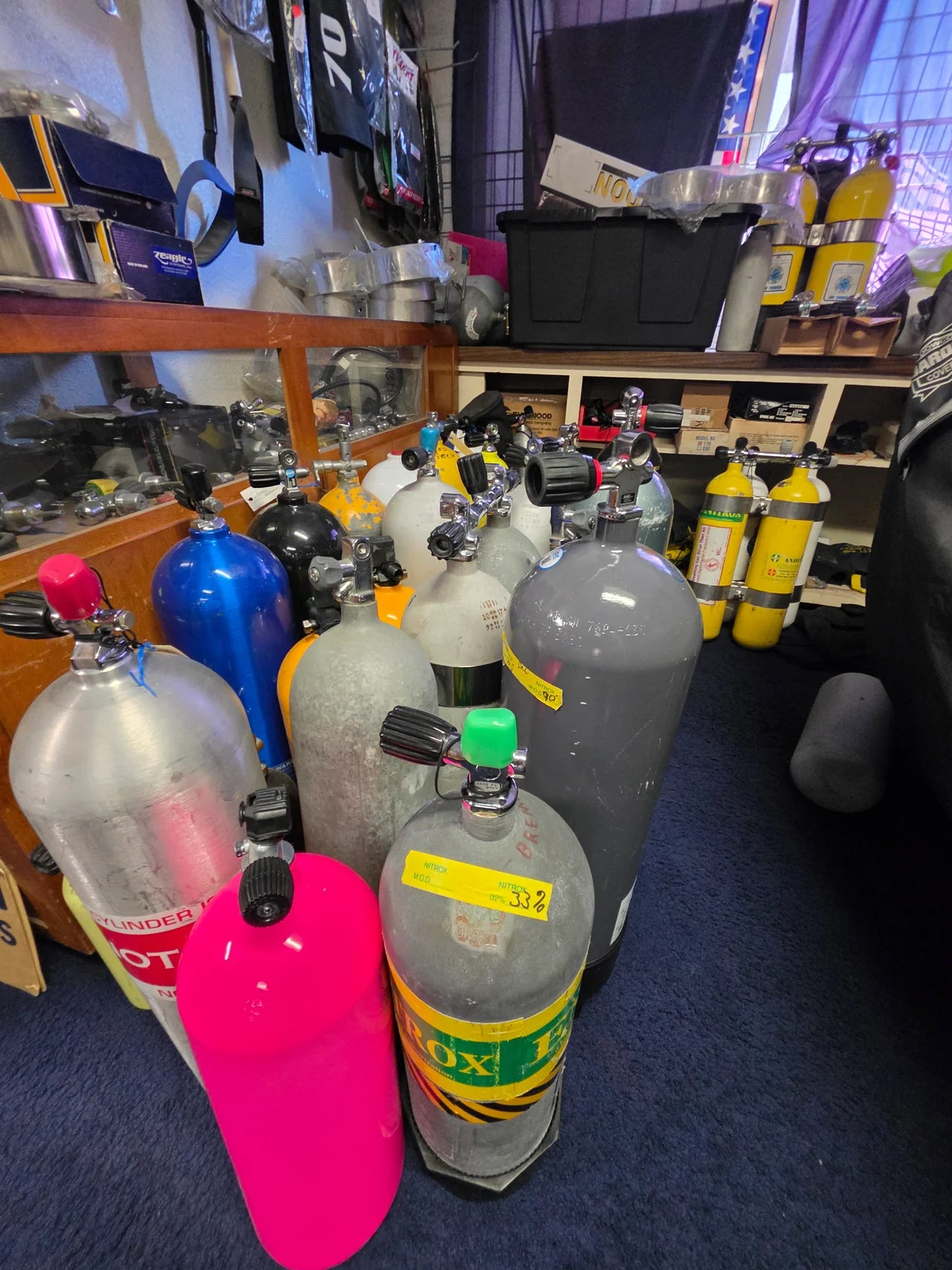 Scuba cylinders, including a nitrox-labeled cylinder, inside the Openwater Habitat shop